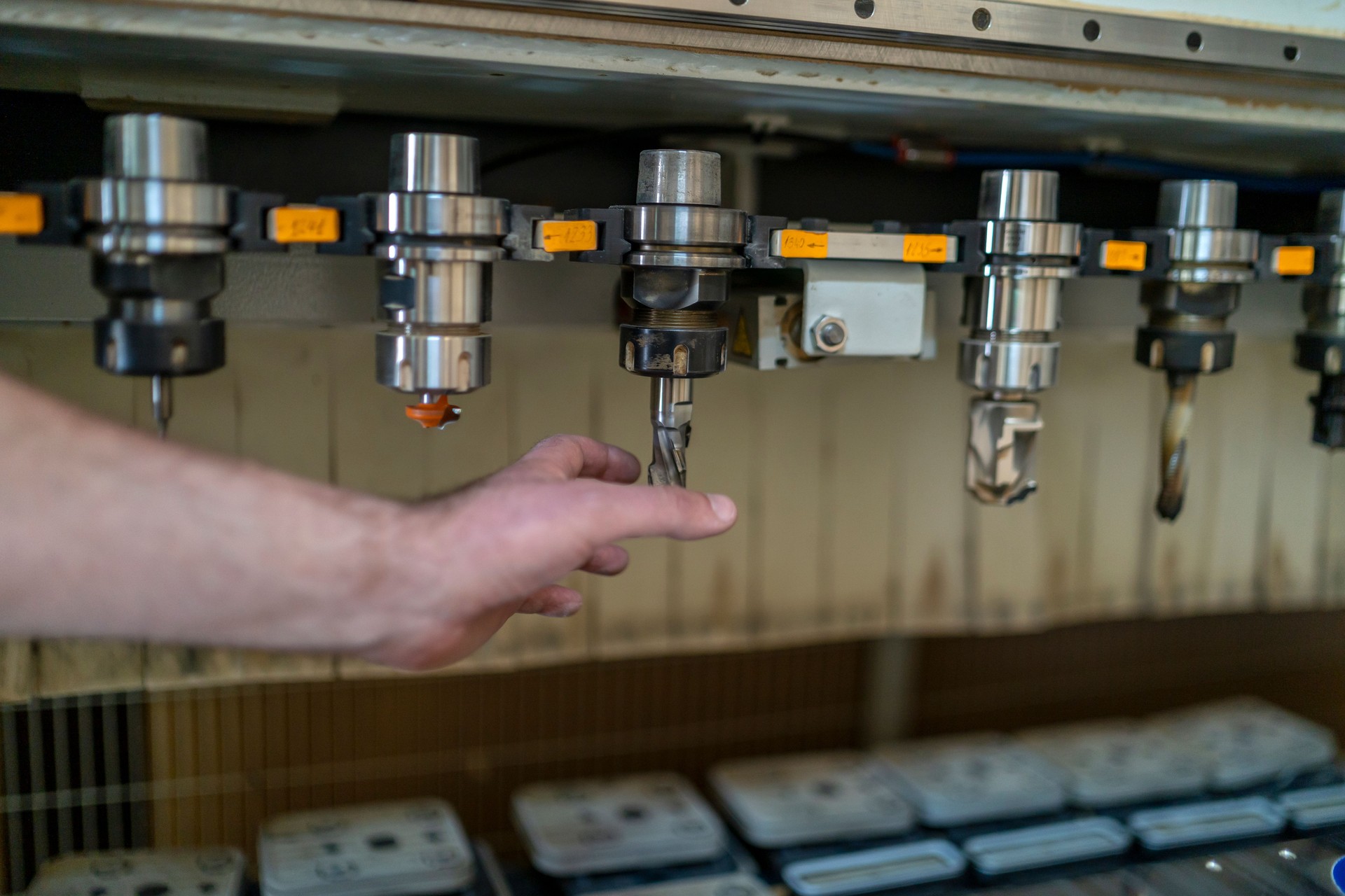 Carpenter in a furniture factory working on a CNC machine.