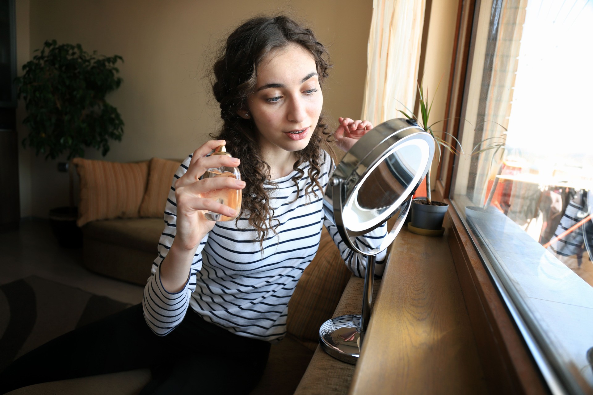 Young woman holding a perfume